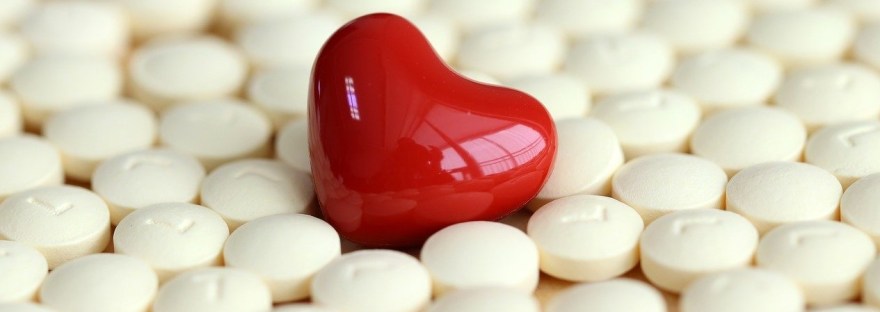 This is an image of medicines and a heart in an article on "Can Modern Medicine Be Holistic?" by Haripriya Suraj, Reiki Master