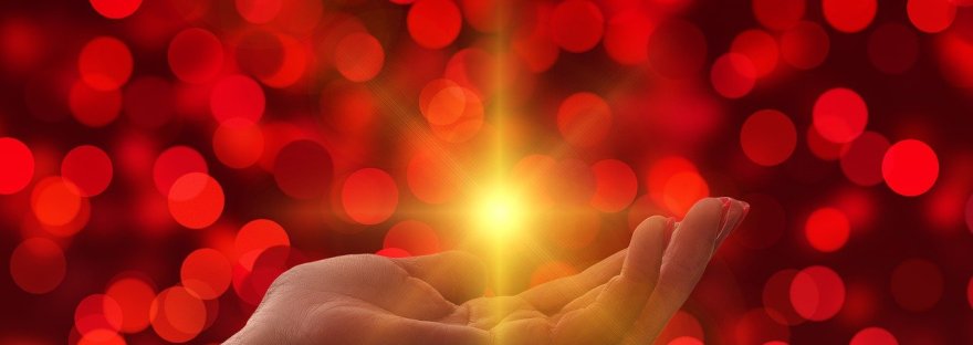 This is an image of a palm radiating light in an article on surrendering to the divine, women's safety by Haripriya Suraj, Reiki master